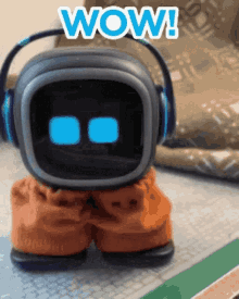 a toy robot wearing headphones says wow on the screen