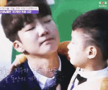 a man in a suit and tie is holding a small child