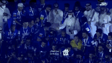 a group of soccer players are posing for a picture with their trophies .