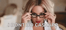 a woman wearing glasses and red lipstick is sitting on a bed and says `` i dont do cashapp '' .