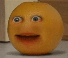 a close up of an orange with a surprised face on it .