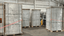 a warehouse filled with lots of wrapped boxes and a sign that says ' no smoking ' on it