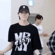 a man wearing a hat and a t-shirt that says mr. ministry