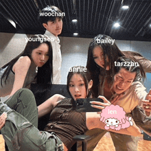 a group of people are posing for a picture and one of them is taking a selfie with the name len on it