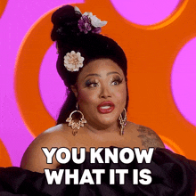 a woman with a flower in her hair has the words you know what it is on her face