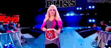 a woman holding a wrestling ring with bliss written on the bottom