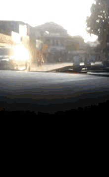 a blurry picture of a street with a few buildings in the background