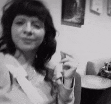 a black and white photo of a woman in a room