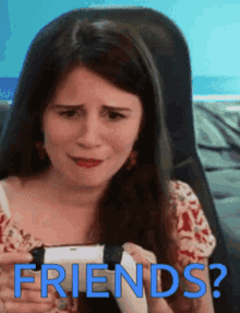 a woman is holding a video game controller with the words friends written on the bottom