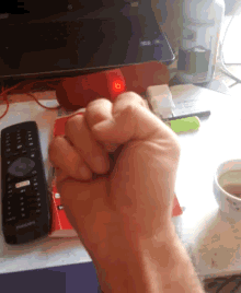 a fist is being held in front of a remote that says netflix