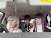 three people in costume are in a car with a warning sign on the rear view mirror