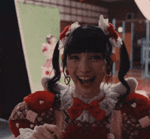 a girl with pigtails is wearing a santa hat