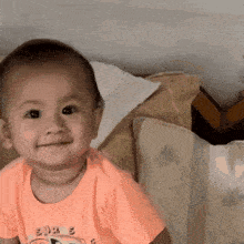 a baby wearing a shirt that says ' sjss ' on it