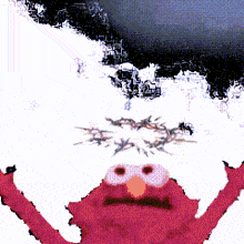 elmo from sesame street is standing in front of a snowy mountain