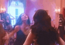 a woman is dancing in front of a mirror in a pink room .