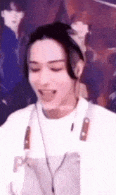 a close up of a person wearing headphones and an apron with a knife on it .