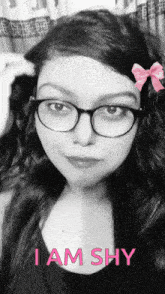 a black and white photo of a woman with glasses and the words i am shy on the bottom
