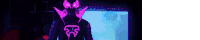 a person in a purple and pink mask is standing in front of a screen .