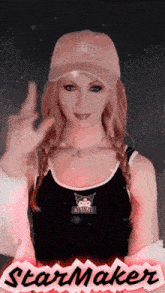 a woman wearing a hat and a tank top that says " kuromi "