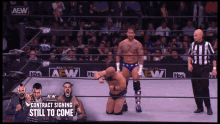 a wrestler is kneeling down in a wrestling ring with a sign that says contract signing still to come