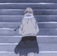 a person in a white hoodie is walking down stairs