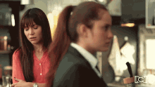 two women are standing next to each other in a kitchen with the letters cc on the bottom right