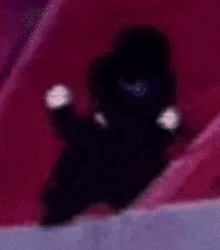 a blurry picture of a person standing in a dark room holding a light .