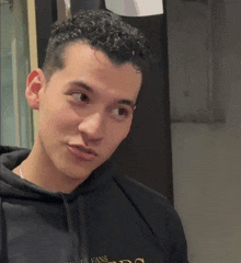 a man wearing a black hoodie that says fans
