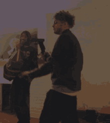 a man and woman are dancing in a living room