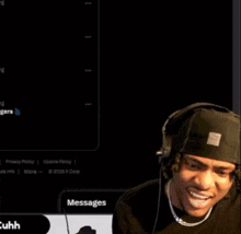 a man wearing headphones and a beanie is smiling in front of a black background .