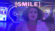a woman is smiling in front of a sign that says i smile