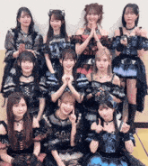 a group of girls posing for a picture with one girl giving a thumbs up sign