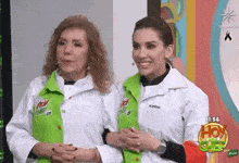 two women are standing next to each other on a television show .