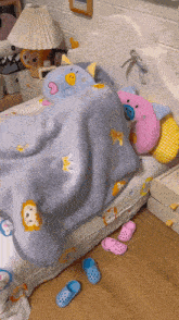 a bed with a blue blanket with a lion on it