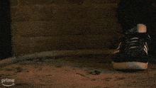 a close up of a person 's foot on a car wheel with the word prime in the corner .