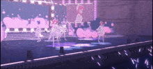 a group of girls are dancing on a stage with a large screen behind them that says ' n ' on it