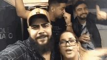 a group of people are posing for a picture together .