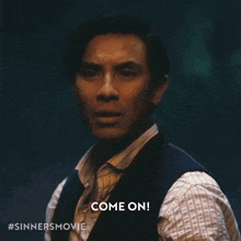 a man in a vest says come on in the dark