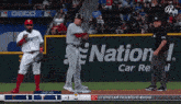 a baseball game is being played in front of a sign that says nation car rental