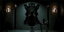 a woman in a red dress is looking at herself in the mirror