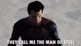 a man in a superman costume is standing in the snow and says they call me the man of steel