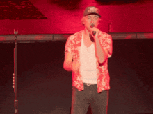 a man singing into a microphone wearing a hat that says ' u.s. navy ' on it