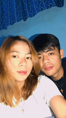 a man and a woman pose for a picture together