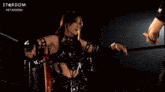 a man and a woman in a wrestling ring with the word stardom on the bottom right