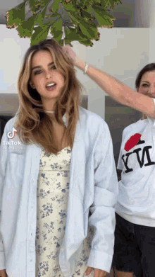 a woman wearing a shirt that says i love nyc is getting her hair done