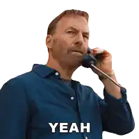 a man in a blue shirt is talking on a telephone and the word yeah is on the bottom