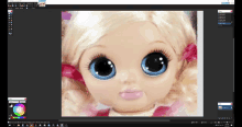 a computer screen shows a doll with big blue eyes and blonde hair