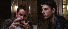 two men in leather jackets are looking at something in their hands