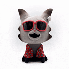 a stuffed animal with a red scarf around its neck is sitting on a white surface