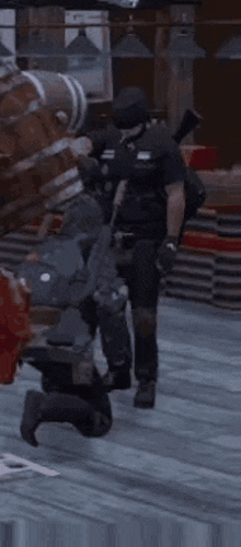 a man in a military uniform is kneeling down next to another man in a video game while holding a gun .